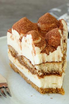 a piece of cake sitting on top of a white plate with a fork next to it