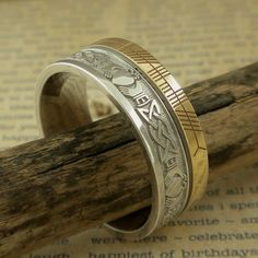 Sterling Silver and 10K Yellow Gold with Claddagh and Celtic Knot Design around the entire ring. A custom personalized phrase in Ogham on 10K yellow rail edge. Claddagh & Celtic Knot Wedding Band with Ogham Script Rail. Handmade in Ireland. 7.5 mm wide. Available in whole & half Sizes 4.5 to 13. Florentine background with polished design, your personalized phrase in Ogham Script on rail edge. Comfort Fit. Irish Hallmark. The phrase is usually a name or word or short phrase. Start a conve Celtic Knot Wedding, Claddagh Ring Wedding, Celtic Dragon, Celtic Knot Designs, Viking Ring, Celtic Knot Ring, Irish Celtic, Celtic Cross, Sterling Silver Mens