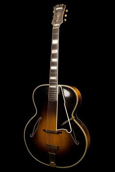 an acoustic guitar is shown against a black background