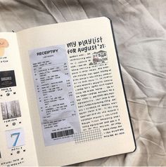 an open book with stickers on it sitting on top of a white bed sheet