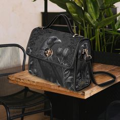 **PLEASE CHECK OUR DELIVERY TIMESCALES PRIOR TO ORDERING.**Our gothic crow canvas satchel bag is the perfect must-have accessory. Accented with black PU leather trims and with two interior pockets. Carry as a top handle bag or use the adjustable strap for carrying on the shoulder. The perfect size for carrying your essentials on the go. Made from quality materials, this dark gothic style bag features a secure magnetic snap closure and adjustable shoulder strap. Please note that the fabric is a c Gothic Crossbody Travel Bag, Gothic Crossbody Satchel For Travel, Gothic Satchel Shoulder Bag For Travel, Gothic Style Travel Satchel Shoulder Bag, Gothic Satchel Shoulder Bag For Everyday Use, Gothic Shoulder Bag Satchel For Travel, Black Gothic Tote Shoulder Bag, Gothic Style Satchel For Everyday Use, Black Gothic Shoulder Bag