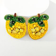 Get these amazing Bumblebee earrings! Bright, eye-catching beads with exquisite detailing, embellished with rhinestones. 🖤Please visit our store to see the rest of our designs. 🖤She'll feel distinguished wearing these handcrafted earrings. 🖤All of them come packaged as gifts, making them ideal presents. 🖤Furthermore, they are lightweight! Send me a message for bulk pricing 🖤Shipping is quite quick; most orders are shipped the same day. 🖤First-class service will be provided. Please upgrade your shipping service if you need the order in 2-3 days! Please check your address again to prevent delays and missed deliveries. Yellow Dangling Beads Earrings For Party, Handmade Yellow Earrings For Party, Unique Yellow Earrings For Party, Yellow Dangle Earrings With Large Beads, Yellow Round Bead Earrings For Party, Yellow Dangle Earrings With Faceted Beads, Yellow Earrings With Large Round Beads, Handmade Yellow Drop Clip-on Earrings, Unique Yellow Beaded Earrings For Pierced Ears