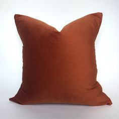 a brown pillow sitting on top of a white table