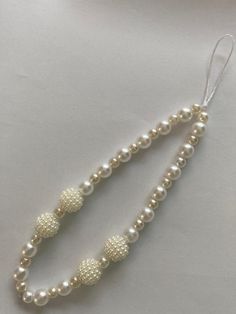 two white pearls and silver beads on a string