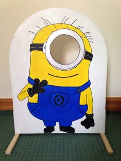 a cardboard cutout of a minion with overalls and an eye patch on it