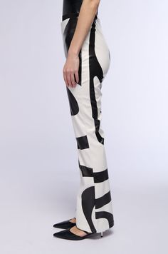 The AKIRA Label Groove On Faux Leather Flare Trouser is made from a slightly stretchy faux leather fabrication and features swirl print patterning, a high rise waist, and a flared leg silhouette. Complete with a tonal side zipper closure. Pair these groovy bottoms with a crop top and platform booties to finish off your dance floor-ready look! - 100% PU  - Little to No Stretch - Spot Clean Only  - Imported  (all measurements approximate from size small)  - 31” Inseam - 11.25“ Rise - Model height is 5’11.5” Product ID: 356529 (all measurements approximate from size 1X)  - 31.75” Inseam - 12.75“ Rise Product ID: 356533 Vintage Band Tees, Flare Trousers, Vintage Band, Faux Leather Leggings, Leather Leggings, Band Tees, Model Height, Ankle Booties, Side Zipper