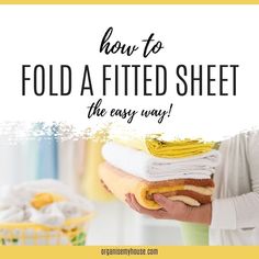 a woman holding towels with the words how to fold a fitted sheet the easy way