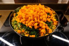 a bowl filled with chopped up vegetables on top of a stove