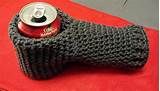 a can holder made out of knitted material on top of a red table cloth