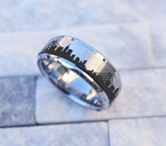 a ring with a city skyline etched on it