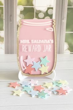 there is a jar with stars on the table