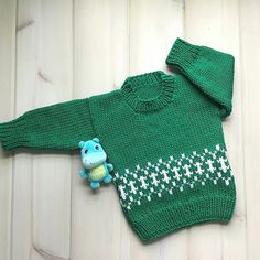 "Size 6 to 12 months, this little baby kelly green sweater has a Fair Isle stitch pattern in white on the lower front and back. Hand knit in a medium weight, acrylic yarn. Machine wash and dry, gentle cycle, low heat, or hand wash and dry flat. Actual chest measurement  ....  20\" (51cms) Sleeve length  8\" (20 cms) Back length   11.5\" ( 29 cms) Please read my policies and FAQ for more information. To view more of my items .... lurayknitwear.etsy.com Shipping will be combined for multiple items Handmade Green Knit Sweater, Cozy Hand Knitted Green Sweater, Cozy Hand-knitted Green Sweater, Green Crochet Knit Sweater, Cute Green Knitted Sweater, Green Long Sleeve Hand Knitted Pattern, Hand Knitted Long Sleeve Green Knitting Pattern, Cozy Green Knitting Pattern, Green Long Sleeve Crochet Sweater