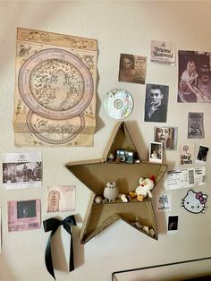 a star hanging on the wall with pictures and other items