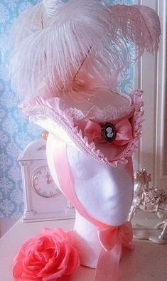 Marie Antoinette/ Rococo (or Late Baroque) Style Child's  Tricorn Hat in Ivory satin w/ pink box pleated satin trim , decorative ivory  edging, pink braided gimp, pink and ivory satin ribbons and Ostrich plumes. In the front is a Cameo piece, a prevailing trend of this fantastic era in fashion. This hat is 9.5 inches from end to end w/ a 5.15 Inch diameter crown and was made to fit a small child (although the same hat could be made for an adult female upon request.  Ideally, I can sew both elast Elegant Costume Hats And Headpieces With Pinched Crown, Elegant Costume Hat With Pinched Crown, Elegant Costume Hats With Pinched Crown, Elegant Adjustable Pink Bonnet, Elegant Costume Hat With Curved Brim, Elegant Curved Brim Costume Hat, Elegant Curved Brim Hats For Costume Party, Elegant Wide Brim Costume Hat, Elegant Costume Hat Headpiece