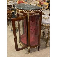 an ornately decorated corner table with glass doors