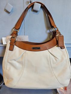 Beautiful vintage Coach with cream leather and saddle leather finishes. Pink Satin inside with large openings! Classic Leather Shoulder Bag With Lined Interior, Leather Shoulder Bag With Double Handle And Lined Interior, Classic Tote Shoulder Bag With Lined Interior, Classic Shoulder Bag With Lined Interior, Classic Shoulder Bag With Lined Interior For Shopping, Classic Beige Satchel With Leather Trim, Leather Shoulder Bag With Lined Interior For Shopping, Elegant Leather Shoulder Bag With Lined Interior, Cream Leather Shoulder Bag With Leather Lining