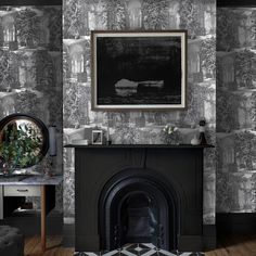 a fireplace in a living room with wallpaper and a painting on the wall above it