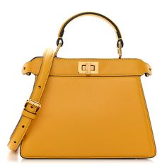 This is an authentic FENDI Shiny Nappa Petite Peekaboo I SEE U Satchel in Mimosa. This chic tote is finely crafted of smooth padded calfskin leather in yellow. This mini-sized bag features gold squared turn locks on either side that when released, relax the outer layer to reveal the inner panel of purple leather with a gold metal bar. It can be carried as a shoulder bag with the optional adjustable shoulder strap or a tote by the top handle. Pokemon Fabric, Fendi Peekaboo Bag, Fendi Shoulder Bag, Fendi Peekaboo, Purple Leather, Metal Bar, Mimosa, Fendi Bags, Pink Brown