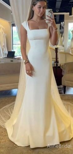 a woman taking a selfie in her wedding dress