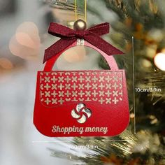 an ornament hanging from a christmas tree with the words shopping money on it