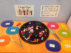 the table is set up with colorful plates and utensils for children to use