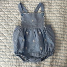 . Blue Soft Fabric With White Flowers And Scallop Accents. Snap Closure And Cross Cross Back. Never Used. Size 3-6 Months. Blue Fitted Bubble Romper For Spring, Spring Fitted Blue Bubble Romper, Fitted Blue Bubble Romper For Spring, Casual Blue Bubble Romper For Spring, Fitted Blue Bubble Romper For Playwear, Blue Casual Bubble Romper For Playdate, Casual Blue Bubble Romper For Playdate, Blue Bubble Romper For Summer Playdate, Blue Sleeveless Casual Bubble Romper