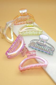 Crescent Shaped Hair Claw Clip: These jumbo acrylic claw clips are everywhere right now, making it so easy to turn a bad hair day into a fabulous one! The hinged, claw-style design makes it so easy to throw your hair up and go! Made of acrylic. Dimensions:• 2 inches x 3.75 inches x 1.5 inches