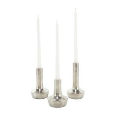 three silver candles sitting next to each other