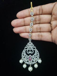 "Handmade Indian Temple Jewelry, best to wear it for traditional ceremonies or Indian wedding. This bridal jewelry has an ethnic finish. It has Cubic Zircon stones with ruby. It is a Bollywood style one gram jewelry. There are long and short patterns of Indian jewelry in Kundan, Pearls, CZ, American Diamond, ruby, emerald, Polki, kemp to suit every occasion of South Indian and North Indian weddings. When you adorn mang tikka on your forehead and it will steal the show. The Mang Tikka has Semi-pr Traditional Stone Work Bridal Accessories For Festivals, Traditional Bridal Accessories With Stone Work For Festivals, Adjustable Stone Work Tikka For Ceremonial Occasions, Bollywood Style Tikka With Tilla For Traditional Ceremonies, Bollywood Style Tilla Tikka For Traditional Ceremonies, Traditional Bridal Sets With Simulated Diamond For Wedding, Traditional American Diamond Bridal Sets For Wedding, Silver Temple Jewelry Tikka For Ceremonial Use, Traditional Silver Tikka For Wedding