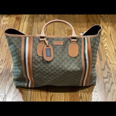 Serious Shoppers Only. Gorgeous And Never Carried Gucci Overnight Travel Bag. Can Be Used As A Large Beach Bag Or Large Travel Tote. This Is From My Personal Collection And I’ve Never Used It So It Is Brand New. No Flaws. Comes From A Non Smoking Home With No Pets/Pests. Comes With Original Cards And Dust Bag. Measures 16*24*5 (Approximately) This Is 100% Authentic. Inside Has A Zipper Pocket. Bag Closes With Clasp Hardware, See Pics. Hardware Is Gold. This Bag Holds A Lot. It’s Big!!! Truly A C Designer Travel Bag With Double Handle For Shopping, Designer Shopping Travel Bag With Double Handle, Designer Rectangular Travel Bag, Designer Double Handle Travel Bag For Shopping, Designer Rectangular Coated Canvas Travel Bag, Designer Travel Bag With Leather Handles For Shopping, Designer Rectangular Travel Bag For Shopping, Monogram Canvas Tote Travel Bag, Designer Brown Travel Bag With Large Capacity