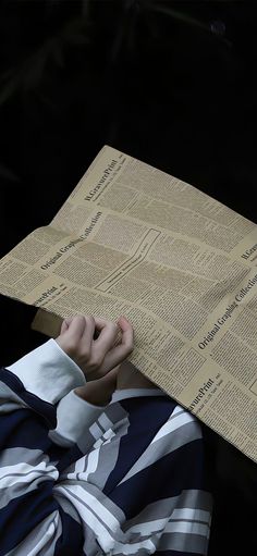 a person with their head under a piece of paper that has been folded over them