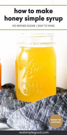 a jar filled with honey sitting on top of a table