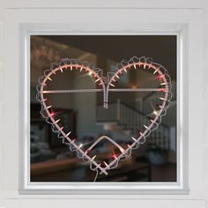 a heart shaped window with lights in it