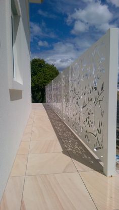 a white wall with an intricate design on it's side and the sky in the background