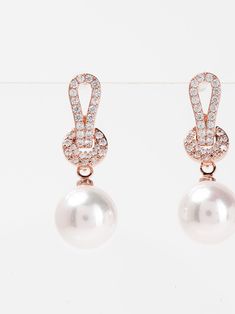 Elevate your style with Jemma Knott's expertly crafted White Gold plated Pearl Drop Earrings. The timeless combination of exquisite pearls and gold plating adds a touch of elegance to any outfit. These beautifully designed earrings are perfect for completing a sophisticated and polished look. SizeL: 1.75" QualityMade with quality materials for endurance. ImportedECZ1560 Classic Rose Gold Pearl Earrings For Parties, Elegant Rose Gold Pearl Earrings For Formal Occasions, Elegant Rose Gold Pearl Earrings For Evening, Rose Gold Pearl Earrings For Formal Occasions, Formal Pearl Earrings For Pierced Ears, Formal White Plated Pearl Earrings, Formal Round Pearl Chain Earrings, Formal Rose Gold Pearl Earrings With Elegant Design, Classic Plated Pearl Drop Earrings