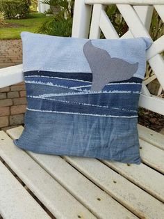 a blue pillow sitting on top of a wooden bench