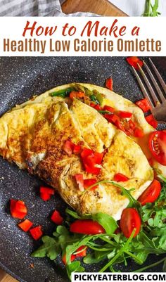 an omelette with tomatoes and spinach on a plate next to a fork