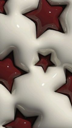 some red and white stars are in the middle of an abstract pattern on a surface