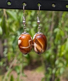 Handmade beaded earrings. Materials sourced locally and upcycled. One in stock. Unique Brown Beaded Earrings For Gift, Unique Brown Beaded Earrings As Gift, Artisan Czech Glass Beaded Earrings, Artisan Czech Glass Round Beaded Earrings, Unique Earrings With Large Round Beads, Handmade Brown Teardrop Beaded Earrings, Dangle Earrings With Large Beads For Gift, Brown Czech Glass Bead Earrings, Nickel-free Brown Beaded Earrings With Czech Glass