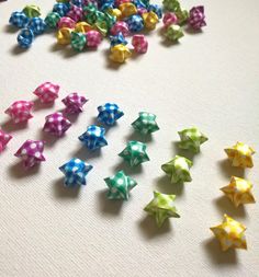 many different colored bows on a white surface