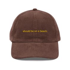 Should be on a beach, and most certainly NOT here. • 100% cotton corduroy • Unstructured, 6-panel, low-profile • Cotton twill sweatband and taping • 6 embroidered eyelets • Adjustable strap with a gold-colored metal buckle • Head circumference: 20″–22″ (50.8 cm–56 cm)Polychrome Goods 🍊 Original Designs ☆ 100% Cotton Twill ☆ Adjustable Strap with Metal Clasp ☆ One Size Fits All Embroidered Hat, Navy And Brown, Embroidered Hats, Vintage Candles, Saved Items, Head Circumference, Metal Buckles, Black And Navy, Low Profile