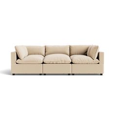 a beige couch with pillows on it