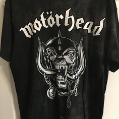 a black motorhead t - shirt hanging on a wall