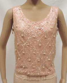 Beaded Blouse 50s Sequin Wiggle Top Pink Wool Sleeveless Shell Christmas Holiday Party Separates Vintage Size S 1950s Beautiful and shiny pink sleeveless shell perfect for holiday, party or casual wear Blouse is fully lined, has back metal zipper closure, bead dangles and is generously covered in iridescent sequins. Size S fabric has some stretch approximate measurements Bust underarm to underarm- 36 inches Waist- 34 inches Shoulder to shoulder-14.5 inches Length shoulder to hem-20 inches Has ma Bead Dangles, Christmas Holiday Party, Sequin Blouse, Sleeveless Knit Top, Beaded Blouse, Hawaiian Dress, Fabric Beads, Beaded Top, Sequin Beading