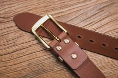 "The 1.5\" wide leather belt is constructed from 10 oz heavyweight Italian vegetable-tanned leather. The item features a solid brass hardware and brass Chicago screws. In many occasions, the leather keeper is a weak spot of a belt. With the brass keeper on this belt, it would surely be the last belt you would ever need. We pay attention to the slightest details, the edges of the belt is beveled and hand burnished with natural beeswax to achieve a smooth and glossy edge finish. With occasional ma Bridle Leather Belt With Brass Buckle For Everyday Use, Everyday Bridle Leather Belt With Brass Buckle, Classic Bridle Leather Belt With Brass Hardware, Everyday Leather Belts With Brass Hardware, Brown Belt With Brass Hardware For Everyday, Brown Leather Belts And Suspenders With Brass Hardware, Leather Belt Buckles With Brass Buckle For Everyday, Italian Vegetables, Chicago Screws