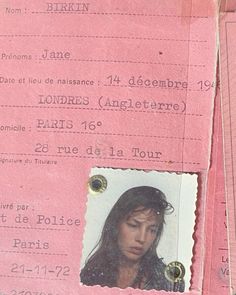 a pink passport with a woman's face in the center and other information on it