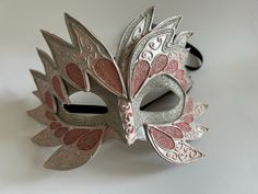 "Beautiful, hand-made, hand-painted mask in the original Venetian Italian Carnival style. This is a genuine molded paper-mache mask, hardened and formed for durability, with pink and silver colors and silver glitter highlights. It has two black satin ribbons in the back for secure tying. Unlike elastic, the ribbons won't stretch out over time, and they add to the beauty of the mask. There is slight wear at some of the \"points\" of the mask, which I have repaired and sealed, but please look care Italian Carnival, Mask Inspiration, Painted Mask, Paper Mache Mask, Halloween Writing, Glitter Highlight, Carnival Mask, Satin Noir, Cool Masks