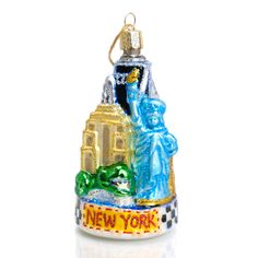 a glass ornament with the statue of liberty and new york on it's base