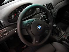 the interior of a car with steering wheel, dashboard and dash board showing buttons on each side