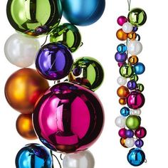 a number one hanging from the side of a christmas tree ornament with multicolored ornaments